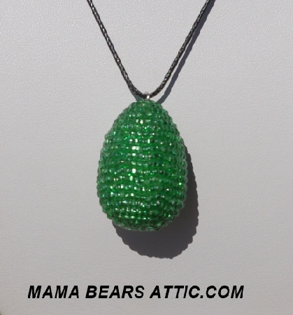 +MBA #5557-0022  "Silver Lined Green Glass Beaded Egg Pendant"
