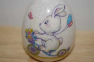 +MBA #10-037  1980's MBA #10-037  Porceline Cracked Finish Bunny On A Bike Egg