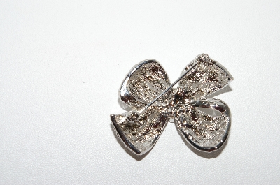 +MBA5  # -1649  Rhodium Plated Clear Crystal Bow Brooch