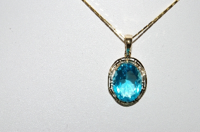 +MBA #80-0079  14k Yellow Gold Oval Cut Blue Topaz Pendant With 18" Chain