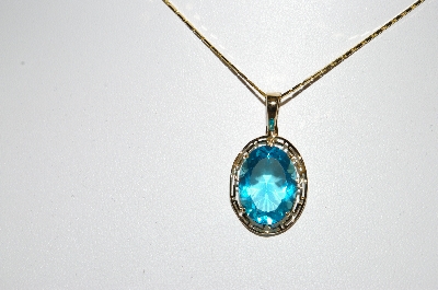 +MBA #80-0079  14k Yellow Gold Oval Cut Blue Topaz Pendant With 18" Chain