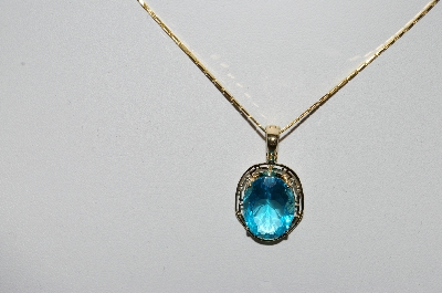 +MBA #80-0079  14k Yellow Gold Oval Cut Blue Topaz Pendant With 18" Chain