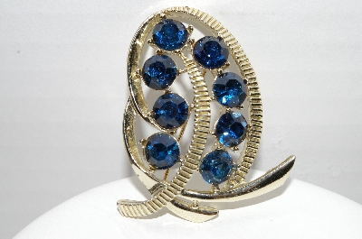 +MBA #92-096 "Kramer Goldtone Blue Rhinestone Swirl Brooch"