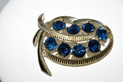 +MBA #92-096 "Kramer Goldtone Blue Rhinestone Swirl Brooch"