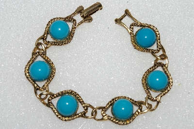 +MBA #E56-075   "Older Antiqued Goldtone Blue Acrylic Stone Bracelet"